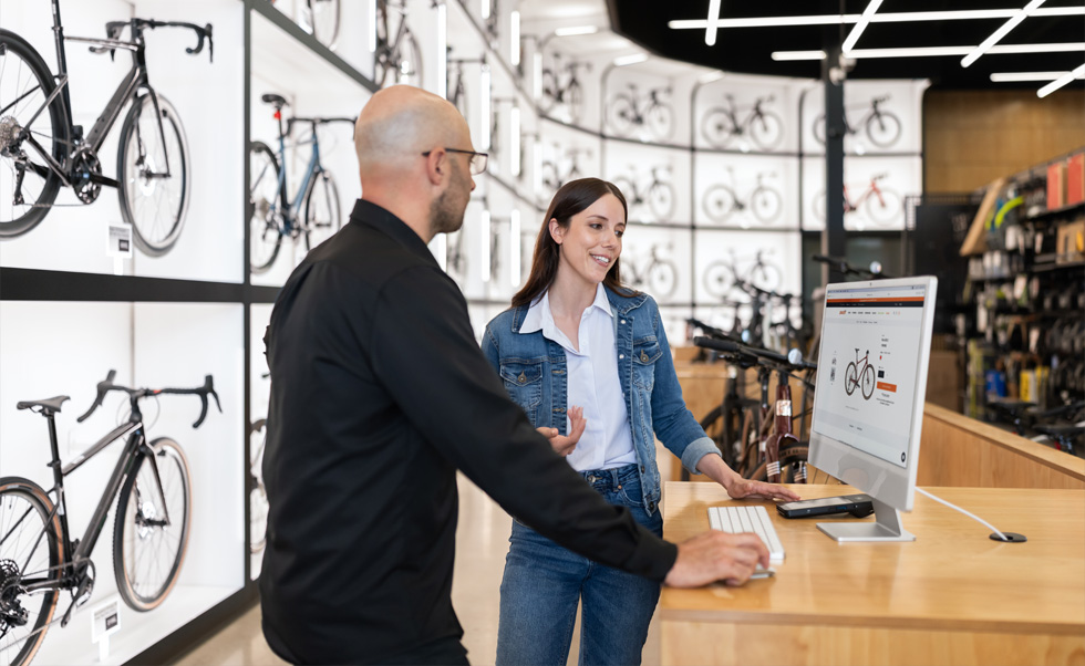 店長のJulien Sicuro氏が、iMacの鮮明なRetinaディスプレイを見ながら、自転車のラインナップについてお客様に説明しています。